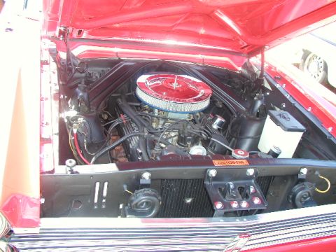 1967 Ford Ranchero - Engine bay of a red 1967 Ford Ranchero, a V8 engine and chrome air cleaner.