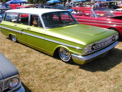 1967 Ford Ranchero - A lime green station wagon with a white roof sits on display at a car show.