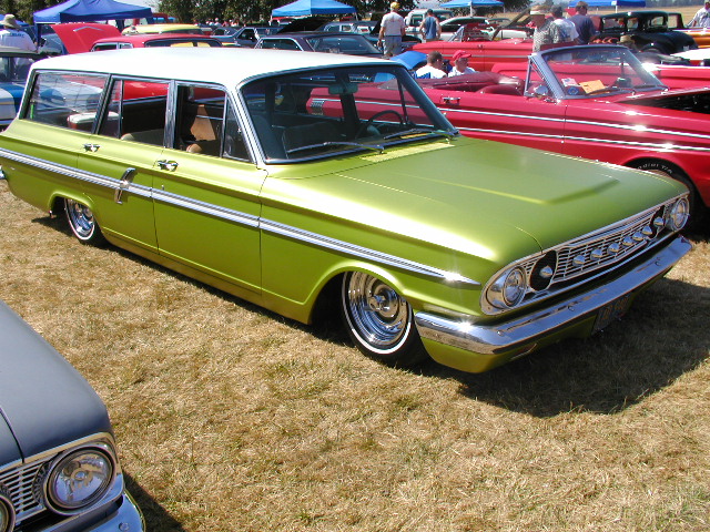 Lime green station wagon with a white roof, lowered suspension, and chrome wheels