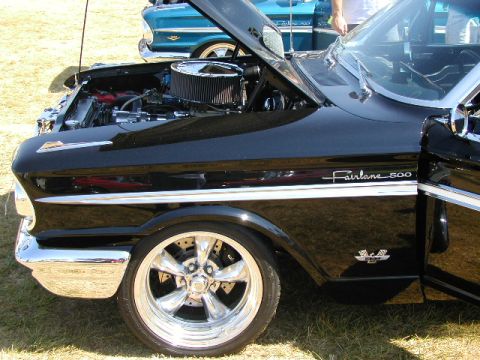1967 Ford Ranchero - A black 1960 Ford Fairlane 500 is displayed with its hood open, revealing the engine and custom wheels.