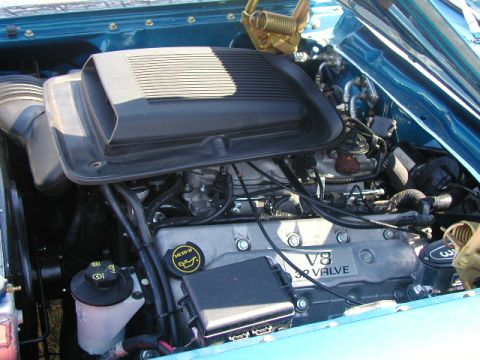 1967 Ford Ranchero - Close-up view of a V8 32 valve engine in a blue vehicle's engine bay.