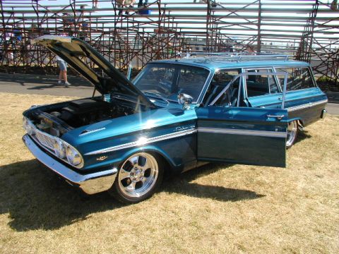 1967 Ford Ranchero - Teal 1961 Ford Falcon Ranchero at a car show, hood and door open.