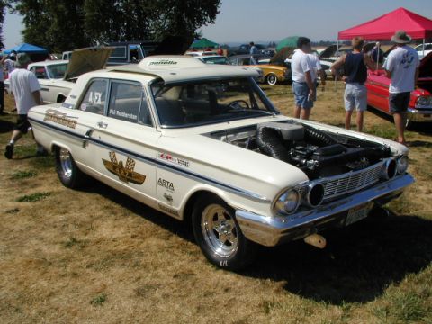 1967 Ford Ranchero - A classic Ford sedan with its hood open at a car show, displaying racing livery.