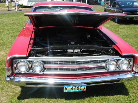 1967 Ford Ranchero - A red 1967 Ford Ranchero GT is displayed with its hood open at a car show.