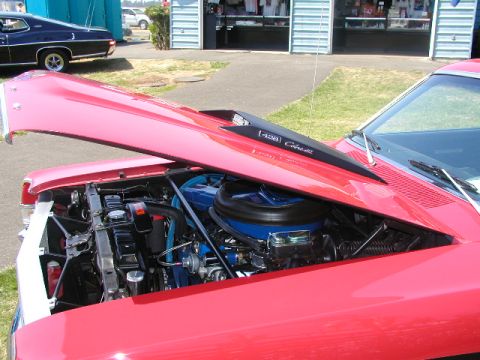 1967 Ford Ranchero - 1967 Ford Ranchero engine bay with Cobra Jet scoop. Another Ford is parked behind it.