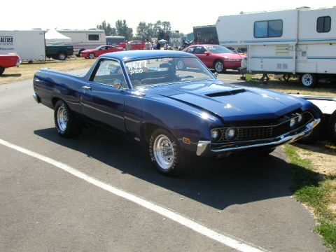 1967 Ford Ranchero - A blue Ford Ranchero is parked at an outdoor event with trailers and other vehicles in the background.