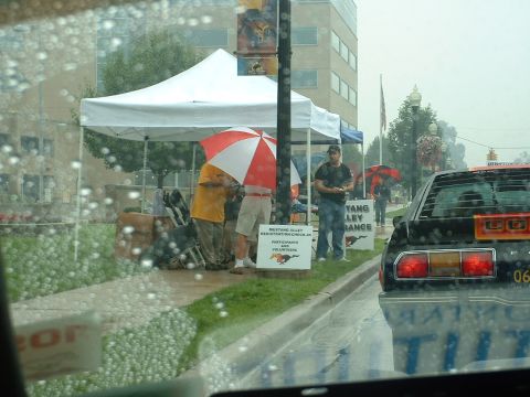 1978 Ford Mustang II - Rainy day at a car show, with a 1978 Ford Mustang II visible.