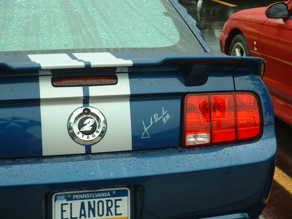 Blue Ford Mustang rear with racing stripes and '2 Stage' badge