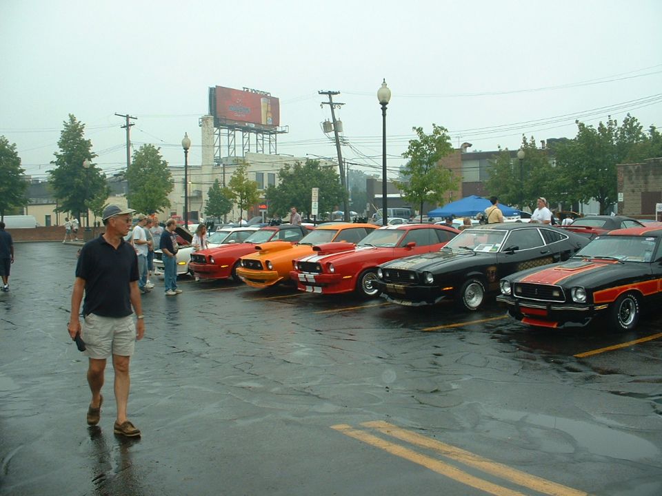 1978 Ford Mustang IIs in a row, black and red stripe on front car