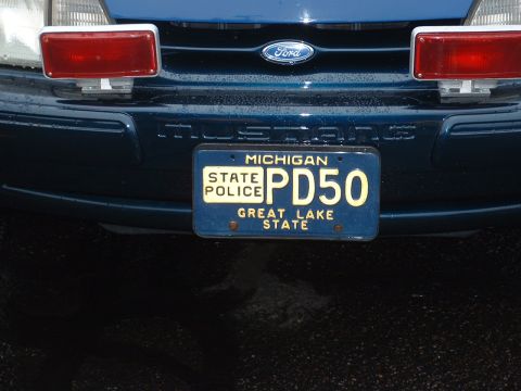 1978 Ford Mustang II - A blue Ford police car is shown from the front, a Michigan State Police license plate.