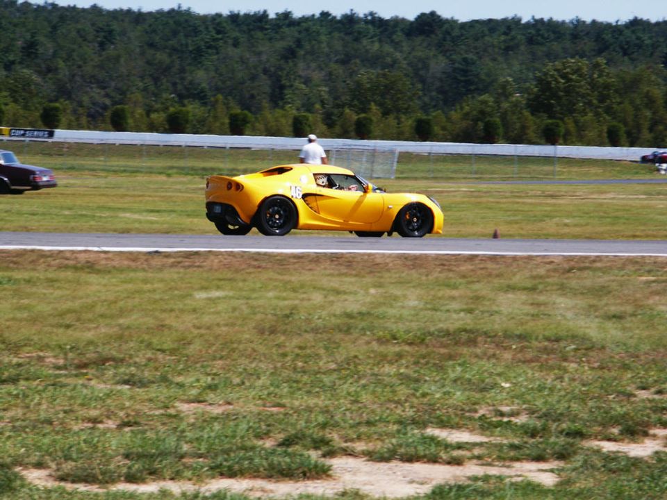 Yellow Lotus Elise on track, number 16 on door