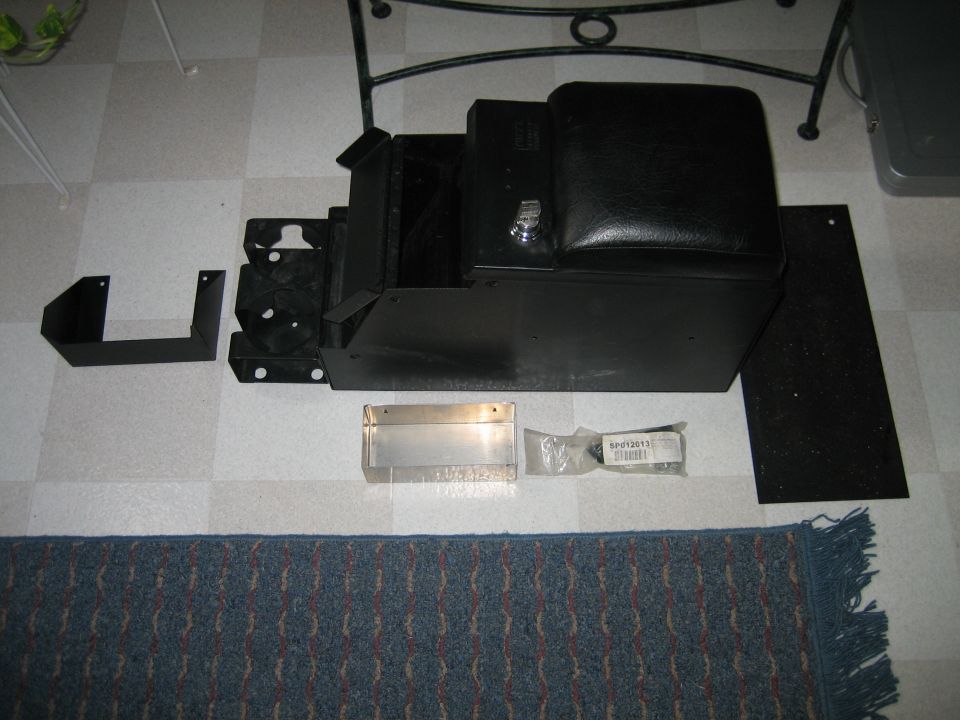 Black center console with parts and hardware