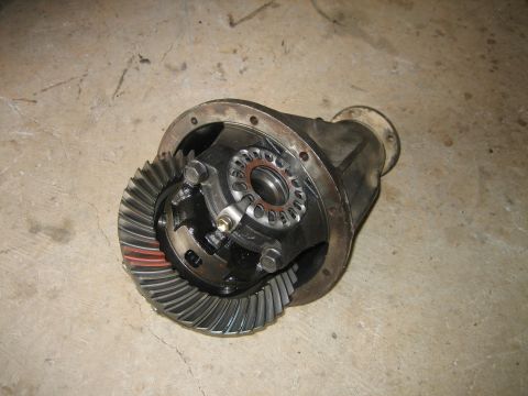 1986 Ford F-150 - A differential assembly, likely from a truck, is shown on a concrete surface.