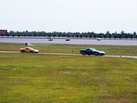 2001 Mercury Grand Marquis - Multiple cars are seen on a race track during an event.