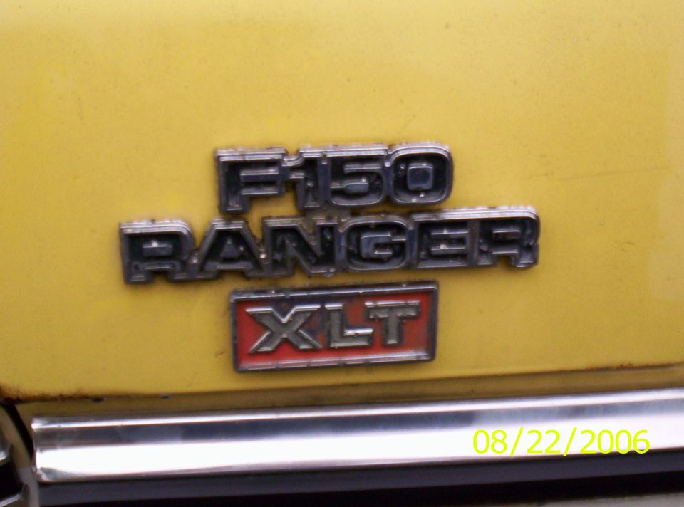 Close-up of F-150 Ranger XLT emblem on yellow vehicle. Date stamp 08/22/2006