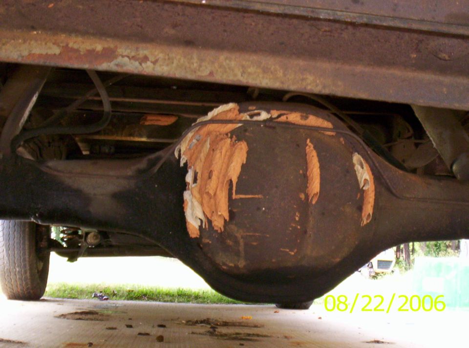 rear axle housing with peeling paint and rust