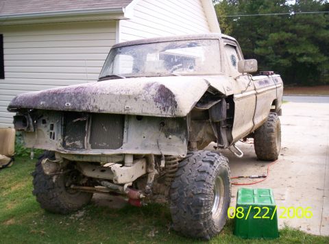 1978 Ford F-150 - This 1978 Ford F-150 truck is in a state of disrepair, with significant front-end damage and mud covering its body.