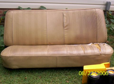 1978 Ford F-150 - A tan bench seat with vertical pleats shows significant wear and tear on the lower cushion.
