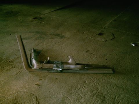 2001 Dodge 2500 - A detached vehicle trim piece lies on a concrete surface, possibly in a garage or workshop.