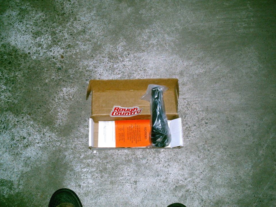 Rough Country steering stabilizer in an open box with instructions