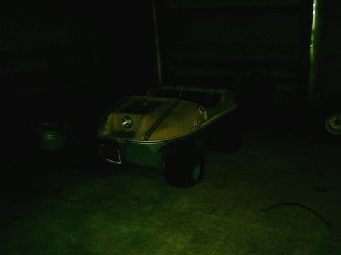 2001 Dodge 2500 - Golf cart with a two-tone yellow and green body is parked indoors.