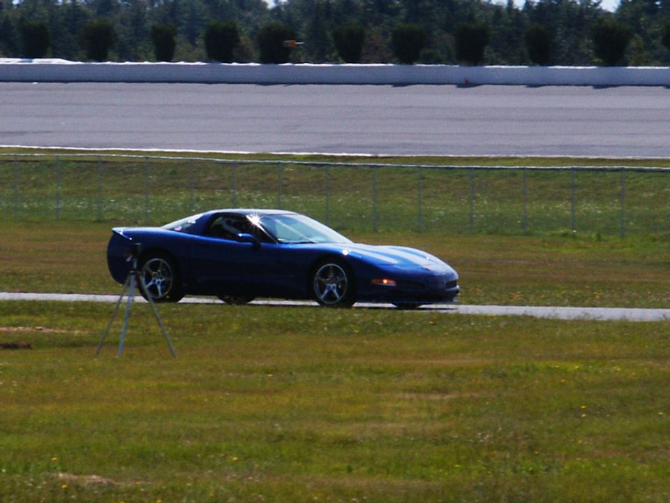 Blue C5 Corvette on a racetrack, side view