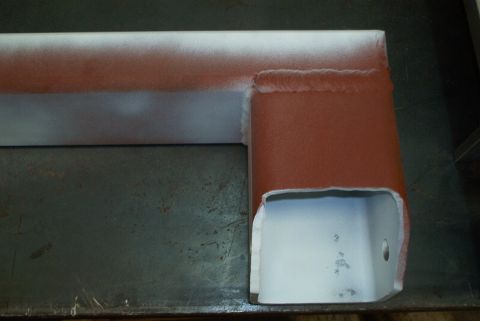 1983 Ford Bronco - A close-up view of a metal frame component, likely a crossmember, with visible welds and cut edges.
