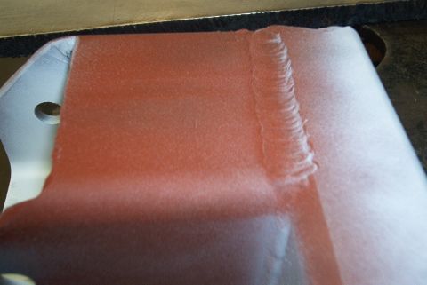 1983 Ford Bronco - Close-up view of a painted metal component, likely a vehicle part, showing weld details.