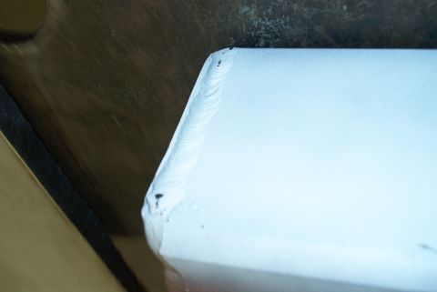 1983 Ford Bronco - This image shows a close-up of a metal part with visible weld seams and imperfections.