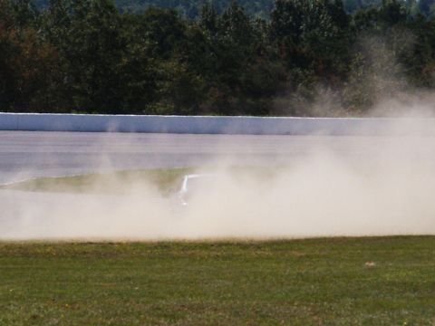 2001 Mercury Grand Marquis - A car is seen on a race track, generating a large cloud of dust.