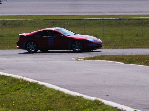 2001 Mercury Grand Marquis - Red Nissan 300ZX (Z32) with racing number '8' on the door, seen on a race track.