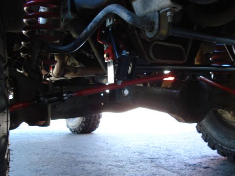 1994 Ford Bronco - Close-up view of a vehicle's undercarriage, showing suspension and steering components.