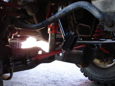 1994 Ford Bronco - Undercarriage view shows aftermarket suspension modifications with red and black components.