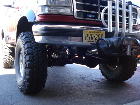1994 Ford Bronco - This lifted Ford truck features a prominent grille and large off-road tires, with a New Jersey license plate visible.