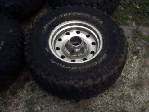 1996 Ford Bronco - A BFGoodrich Mud Terrain T/A tire mounted on a silver 5-lug wheel is shown close-up.