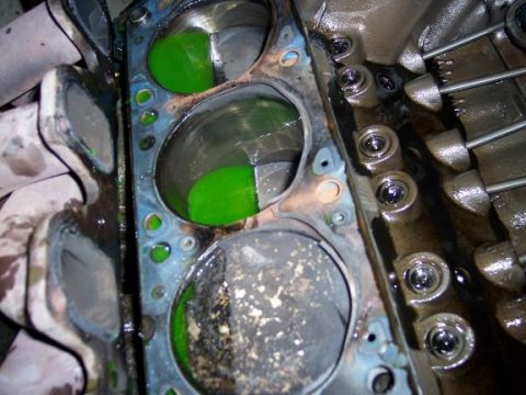 1972 Ford Ranchero - Close-up of an engine block showing cylinders filled with green coolant and exposed pistons.