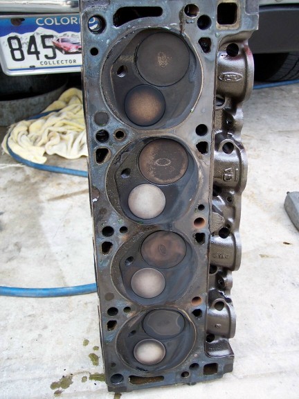 1972 Ford Ranchero - Engine cylinder head with four sets of valves and combustion chambers. Part number visible on side.
