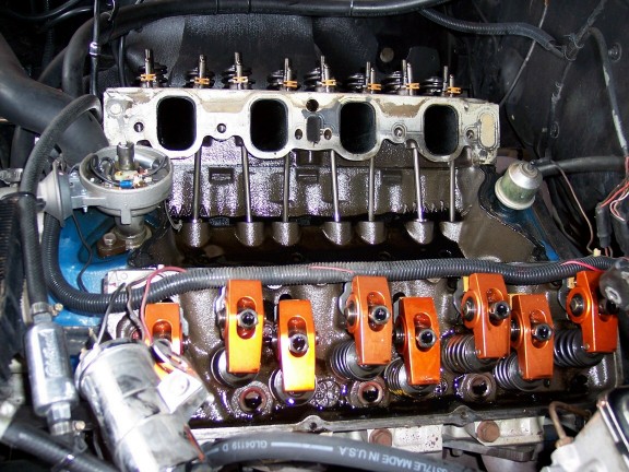V8 top end with valve covers removed showing orange roller rockers and valve springs