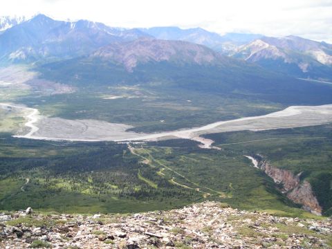 2003 Jeep TJ - Expansive view of a mountain range, a braided river, and a dramatic canyon carved into the landscape.
