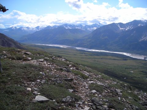 2003 Jeep TJ - Expansive view of a river valley surrounded by mountains under a cloudy sky.
