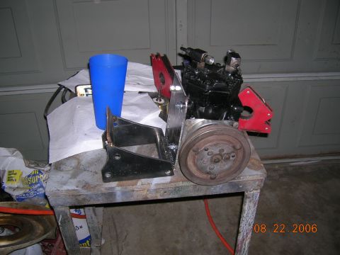 1985 Ford Bronco - An engine compressor assembly sits on a workbench, dated 08.22.2006.