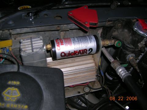 1985 Ford Bronco - Close-up of an engine bay with a QuickAIR 2 compressor and associated plumbing.