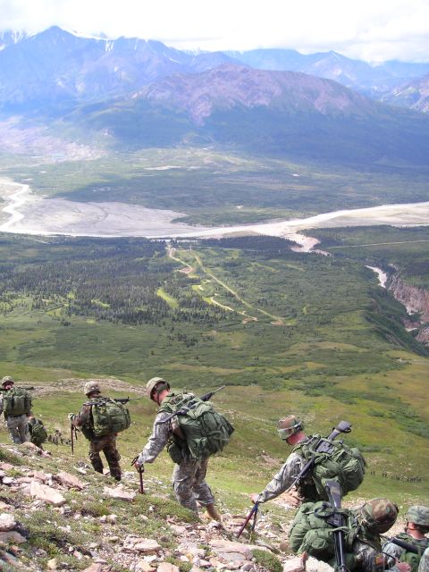 2003 Jeep TJ - A group of soldiers ascend a mountain, their gear heavy as they navigate the terrain.