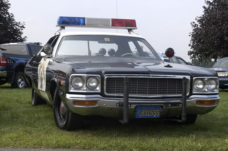 1978 Dodge Monaco police car, front view, with light bar and California license plate 831555