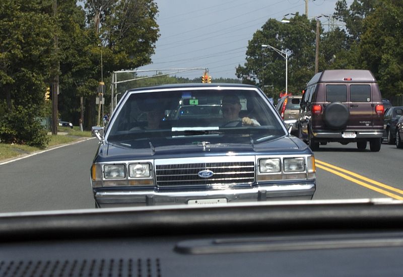 Dark blue 1980s Ford LTD Crown Victoria sedan facing camera in traffic