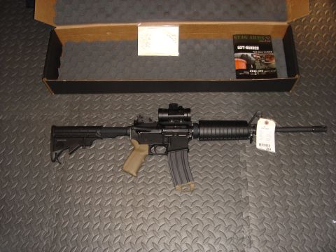1990 Ford Bronco - An AR-15 style rifle is displayed with its accessories and packaging.