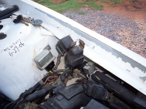 1990 Dodge Shadow - Close-up of the vehicle's electrical components and wiring harness, with a handwritten note indicating a new battery was installed.