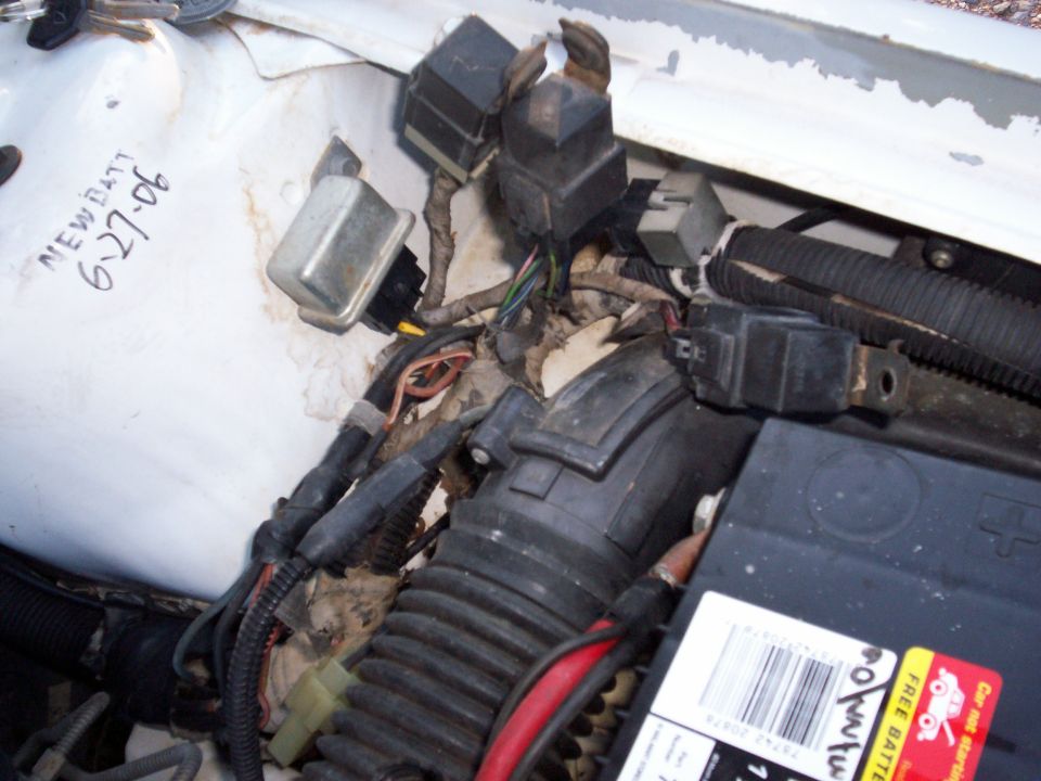 1990 Dodge Shadow engine compartment wiring with handwritten 'NEW BATT 6-27-06' on white surface
