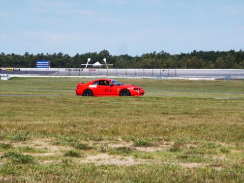 2001 Mercury Grand Marquis - A red 2001 Ford Mustang Cobra with racing number 81 is seen on the infield grass at Pocono Raceway.