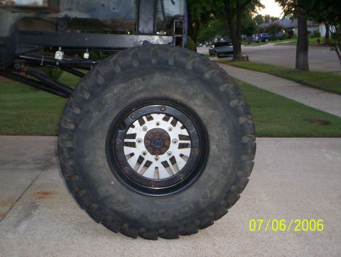 1983 Ford Bronco - Close-up of a large tire and wheel assembly mounted on a vehicle's frame.